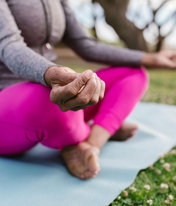 Woman in a calm yoga pose, focused and serene.